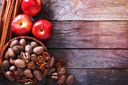 Fall harvest concept - nuts, apple, spices and pumpkinsの写真素材