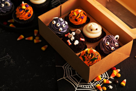Halloween cupcakes with variety of decorations in a to go boxの写真素材