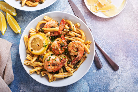 Shrimp piccata pasta with lemon, capers and parmesan in a pasta bowlの写真素材