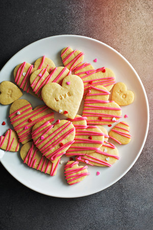 Vanilla sugar cut out cookies with pink glaze and sprinkles for Valentines Dayの写真素材