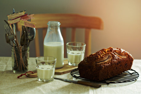 Banana bread with milk on a tableの写真素材