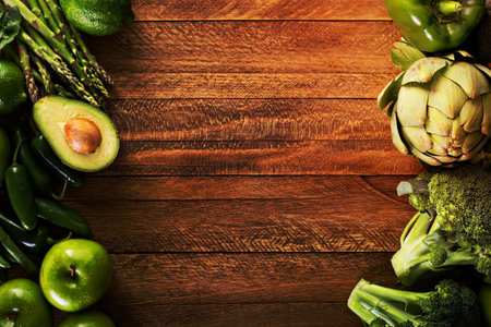 Variety of green vegetables and fruits copyspace on wooden tableの写真素材