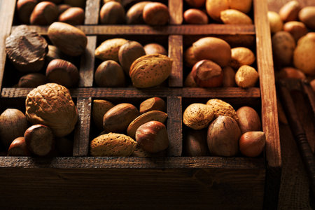 Various nuts in shell in a wooden boxの写真素材