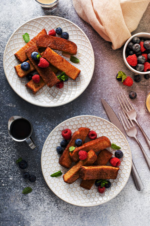 French toast sticks with maple syrup and fresh berries, made in an air fryerの写真素材