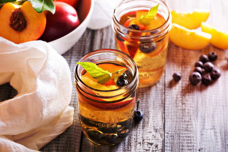 Green iced tea with fresh nectarines and blueberriesの写真素材