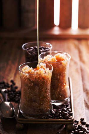 Coffee granita in small glasses with caramel syrupの写真素材