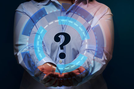 a woman in a striped shirt stands on a blue background, a holographic scheme and a question mark, concept of answers and questions, suspense and solution methodsの写真素材