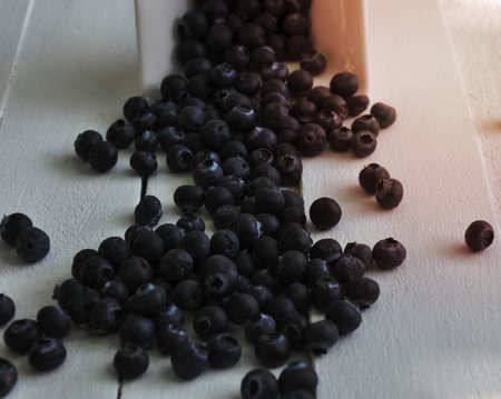 sprinkled ripe blueberries on white wooden tableの写真素材