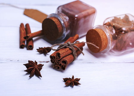 cinnamon sticks and star anise on white wooden backgroundの写真素材