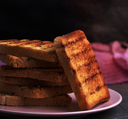 fried French toast on a ceramic pink plate, close upの写真素材