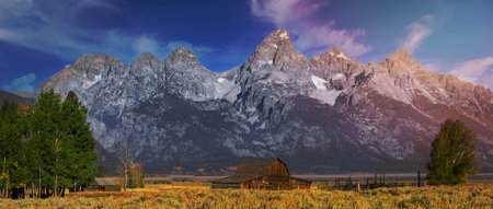 Historic Mormon barn in front of Teton mountain range in Grand Teton national park.の写真素材