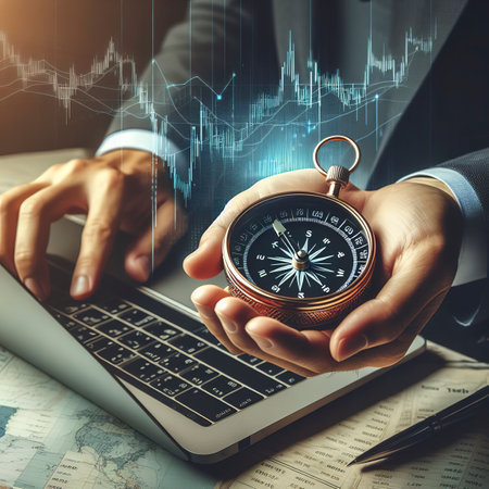Businessman holding compass in hands, and data analyzing with using laptop stock market graphの素材