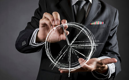 businessman hand drawing a pie chartの素材