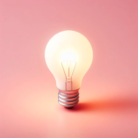 Minimalism light bulb with a blink on pink background. Object and creative idea symbol conceptの素材