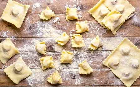 Cooking italian ravioli on wooden tableの素材