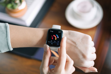 Hand using smartwatch for playing musicの素材