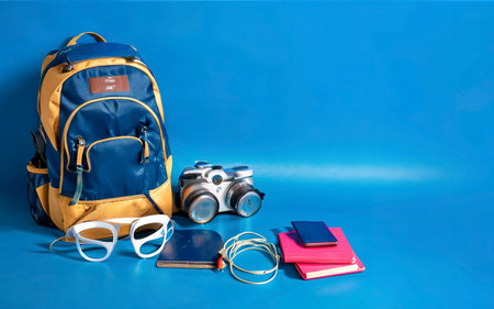 Put on the Luggage. concept accessory for travelers Vacation with a map, passport on Blue color backgroundの素材