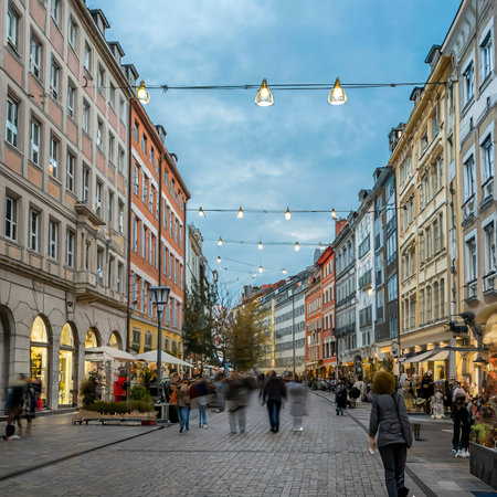 People are walking though a shopping street towards Marienhof in Munich at the Evening, Germanyの素材