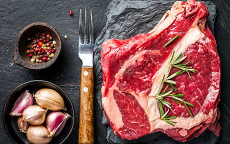 Raw steak Ribeye entrecote on vintage stone background. top viewの素材