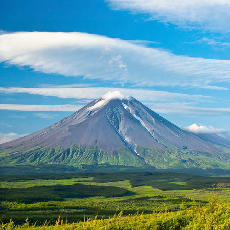 Summer view of volcano on Kamchatka, under blue sky with clouds.の素材