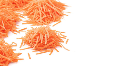 fresh shredded carrots isolated on white backgroundの素材