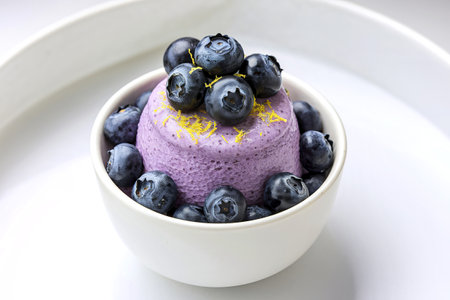 A photo of a cup filled with a vibrant creamy purple mousse dessertの写真素材