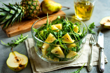 Salad with pineapple, pears and arugula in glass bowl. French gourmet foodの写真素材