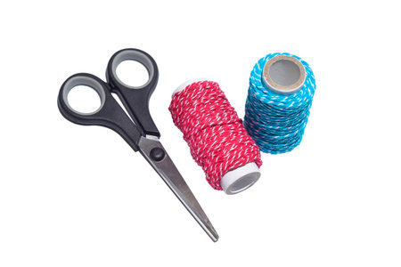 two thread with scissor on white isolated background