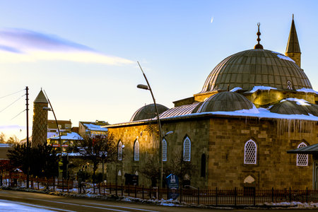 Winter dawn light illuminates Yakutiye Madrasa and Lalapasa Mosque in Erzurum, showcasing historical...