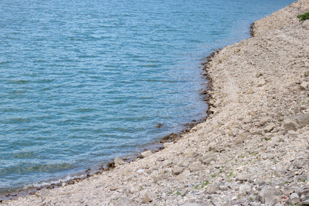 Rocky shoreline of Tortum Lake in Erzurum, Turkey, showing the serene waters.の写真素材