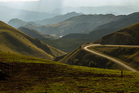 Stunning mountain landscape with winding road, symbolizing exploration, journey, and serenityの写真素材