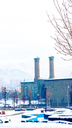 Winter beauty of Erzurum Twin Minaret Madrasa and Ulu mosque covered in snow.の写真素材