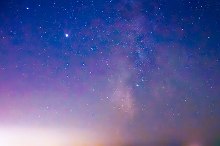 An extraordinary view of the night sky filled with shimmering stars and cosmic hues, reflecting the...