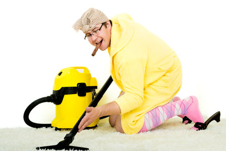 crazy carpet cleaner vacuuming with vacuum cleaner in the yellow robeの写真素材