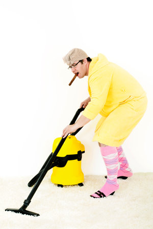 crazy carpet cleaner vacuuming with vacuum cleaner in the yellow robeの写真素材