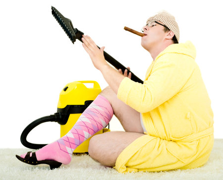 crazy carpet cleaner vacuuming with vacuum cleaner in the yellow robeの写真素材
