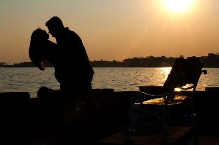 at sunset silhouette of a couple in loveyoung couple in loveの写真素材