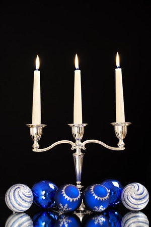 candlestick with three candles and blue balls for the Christmas tree as a Christmas and New Year decorationの写真素材