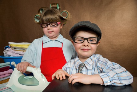 little wife diligently irons, what Meanwhile her husband came home from work Abol. vintage-lookingの写真素材