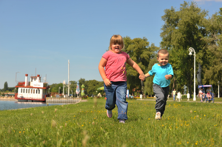 children running on the grassの写真素材