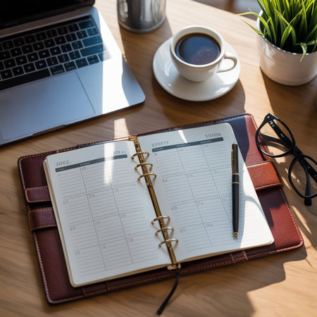 Notebook with pen and coffee on wood table, business planning conceptの素材