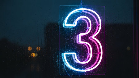 A vibrant neon sign displaying the number three, glowing with a mix of blue and pink hues. The sign is mounted on a dark background, possibly a window, with raindrops visible, adding a sense of depth and atmosphere. The neon lights create a striking contrast against the dark backdrop, making the number three the focal point of the image.の素材