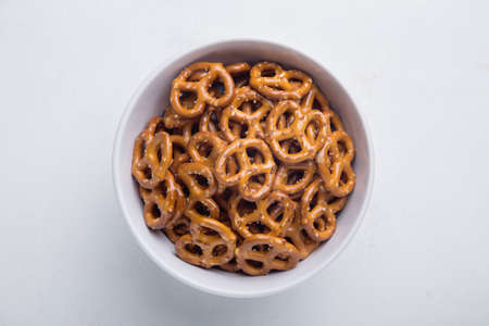 Homemade mini pretzels in a bowl on an isolated backgroundの写真素材