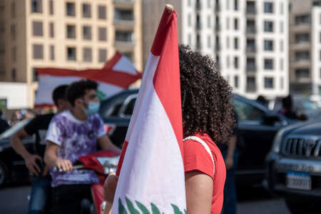 Martyrs Street - 8 8 2020: Lebanon Flag in hand of Lebanese Protesters Protesting in Beirut after the Massive explosion in City Portのeditorial素材