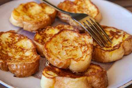 Pain Perdu French Breakfast Plate with golden fork on it | Fried Baguette Bread and butter slices...
