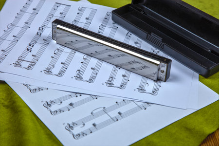 Harmonica Musical Instrument with Music Sheet Notes Reflectionの写真素材