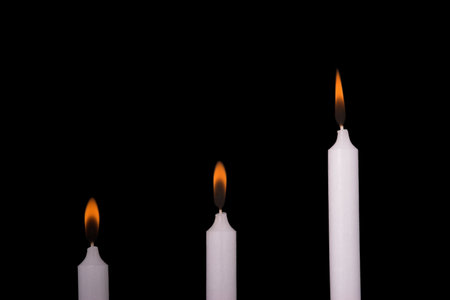 Three candles and candlelightの写真素材