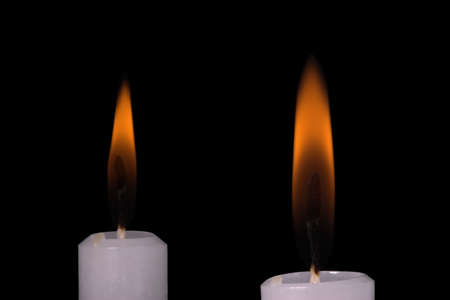 Two candle flames on black backgroundの写真素材