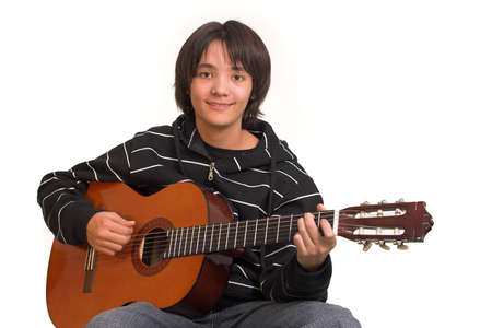 Smiling boy playing guitar on white backgroundの写真素材