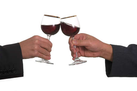 Real clinking. The photo was taken at the moment the glasses clinking as the level of the wine in glasses shows it's movement.の写真素材
